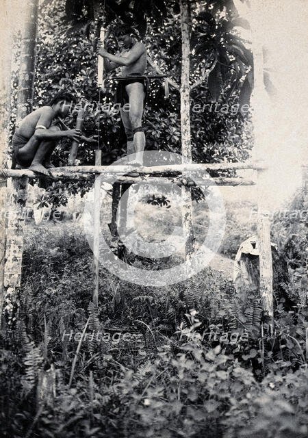 Sarawak: two Kenyah people boring a blowpipe, c1900. Creator: Unknown.