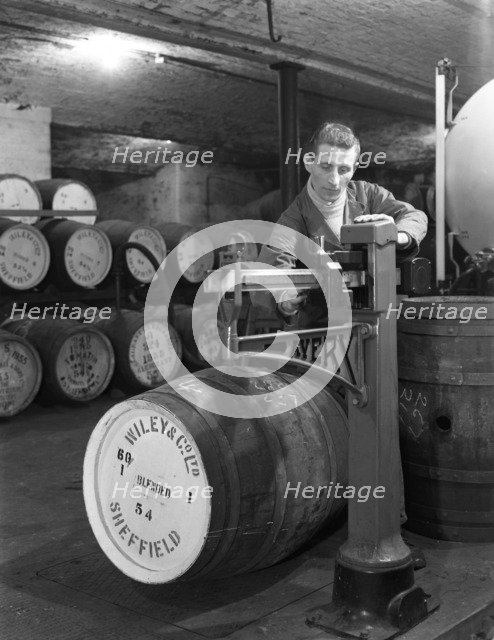 Weighing barrels of blended whisky at Wiley & Co, Sheffield, South Yorkshire, 1960. Artist: Michael Walters