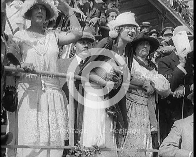 A Large Crowd of Civilians Wearing Smart Outfits and Hats Watching a Horse Race, 1920. Creator: British Pathe Ltd.