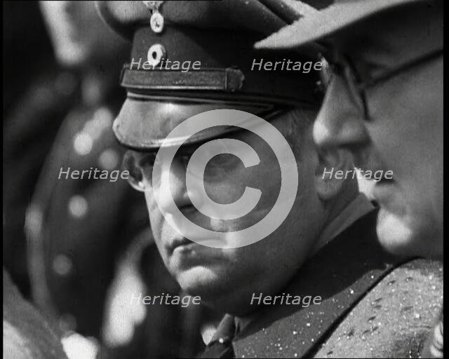 Three Men in a Crowd Listening to a Speech, 1930s. Creator: British Pathe Ltd.