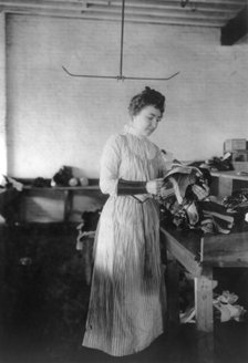Woman distributing work in a shoe factory, Lynn, Mass., (1895?). Creator: Frances Benjamin Johnston.