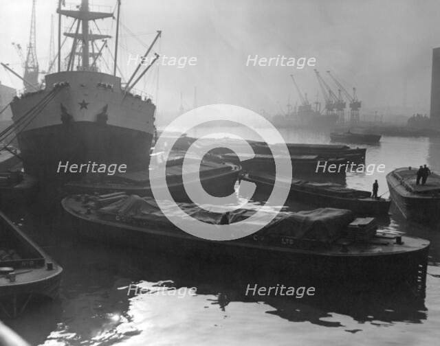 Barges and cargo ships on the River Thames, Pool of London, 1950s. Creator: Arthur Charles Kirby Ware.