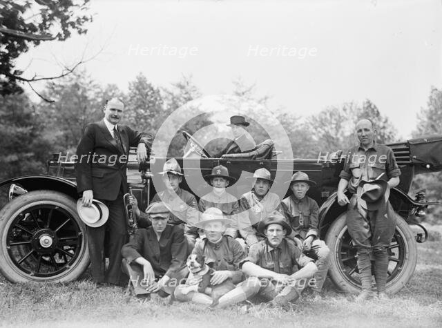 Group of Boy Scouts Posed with Dog And Three Men in Front of An Automobile, between 1914 and 1917. Creator: Harris & Ewing.