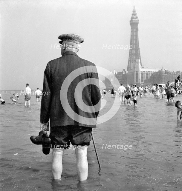 An elderly man paddling in the sea, Blackpool, c1946-c1955. Artist: John Gay