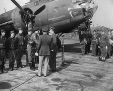 Two Male Officers Talking to a Group of Pilots in front of a Bomber Aircraft, 1943-1944. Creator: British Pathe Ltd.