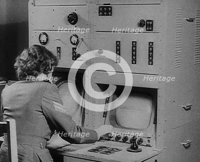 A Woman Operating a Radio, 1940. Creator: British Pathe Ltd.