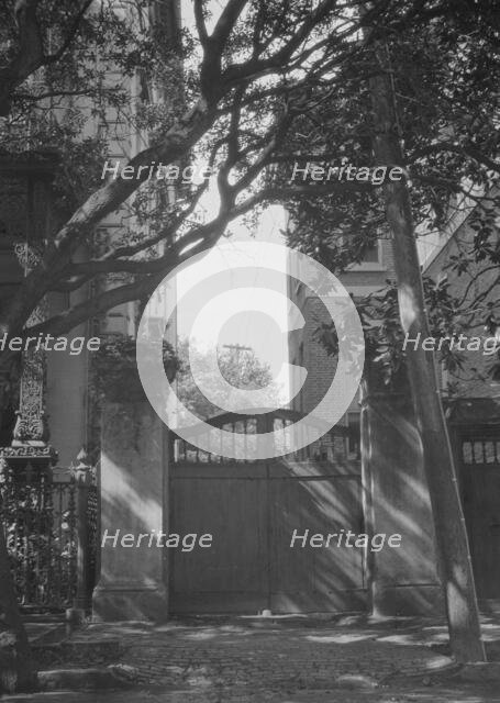 Gate between two buildings, New Orleans, or Charleston, South Carolina, between 1920 and 1926. Creator: Arnold Genthe.