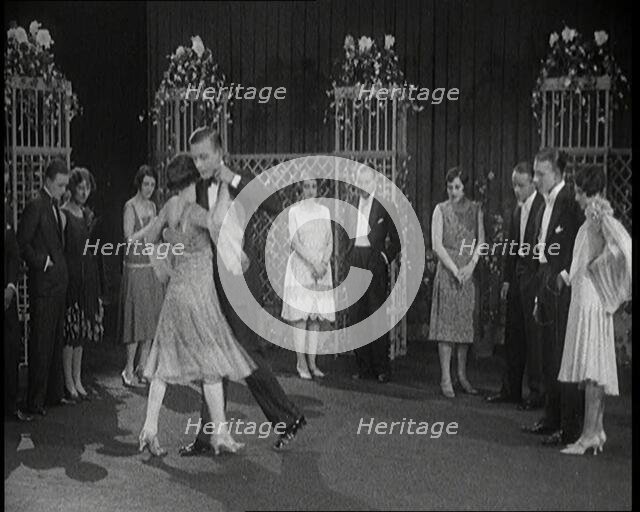 A Group of People Dancing the Charleston. One Female Civilian is Rubbing Her Legs is Pain, 1926. Creator: British Pathe Ltd.