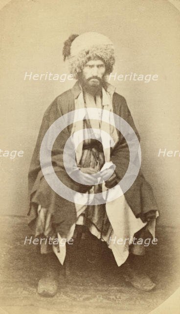 Full-length portrait of man, seated, facing front, between 1870 and 1886. Creator: Unknown.