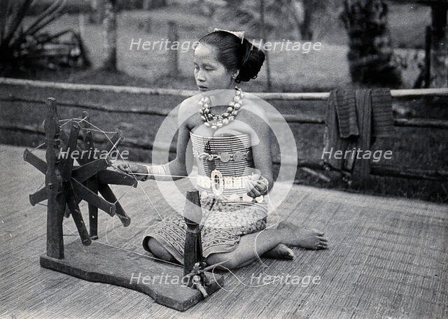 Sarawak: a girl spinning cotton into thread, c1900. Creator: Unknown.