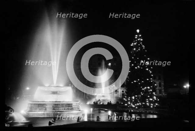 Fountains and the Christmas tree in Trafalgar Square, London, December 1948. Artist: Julian J Samuels.