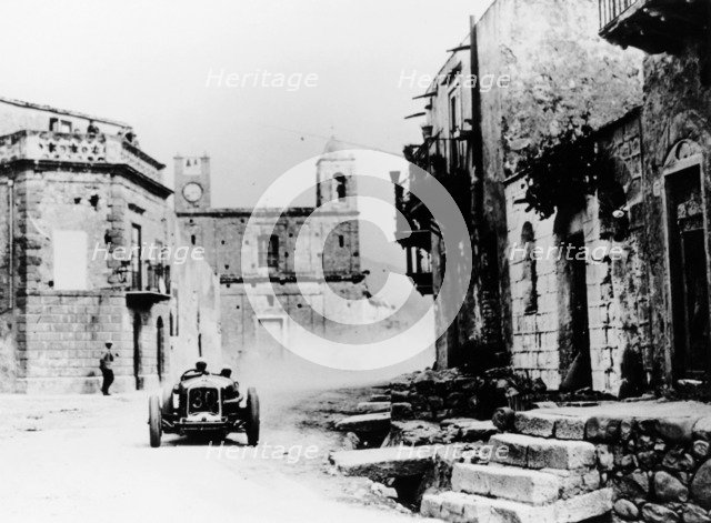 Achille Varzi in a P2 Alfa Romeo Grand Prix car, in the Targa Florio race, Sicily, 1930. Artist: Unknown