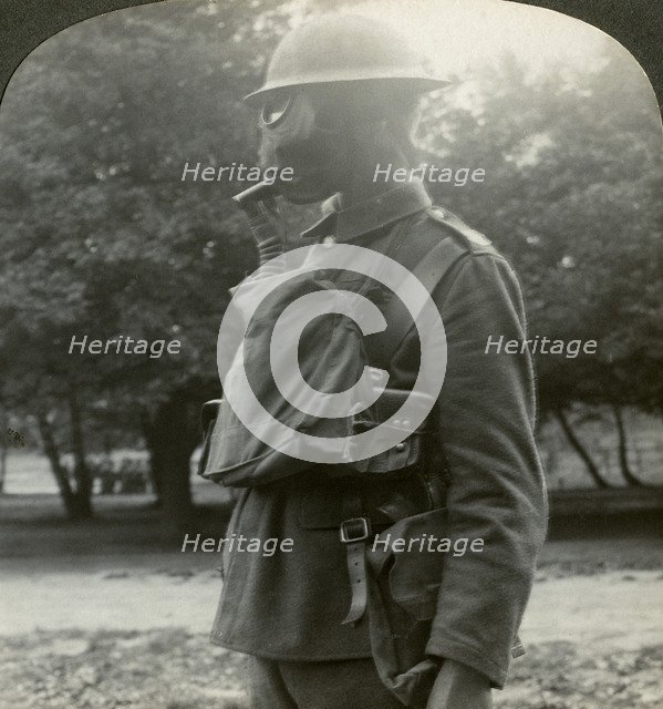 Infantry fitted with the latest gas marks and steel helmets, World War I, 1915-1918.Artist: Realistic Travels Publishers