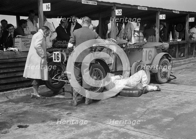 Mechanic working on a Lea Francis J type at the JCC Double Twelve race, Brooklands, May 1931. Artist: Bill Brunell.