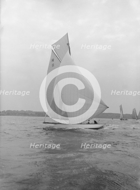 'Ventana' (H11), and early 8 Metre yacht, running downwind under spinnaker, 1913. Creator: Kirk & Sons of Cowes.
