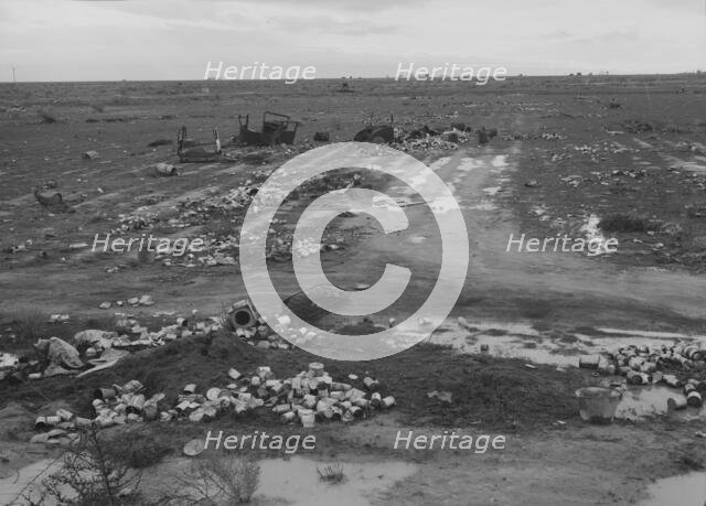 Debris left out on the flats where squatters' camp stood, Kern County, 1939. Creator: Dorothea Lange.