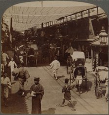 'Mid-summer traffic under awnings of Shiro-bashidori, a busy thoroughfare of Kyoto, Japan', 1904.  Artist: Unknown.