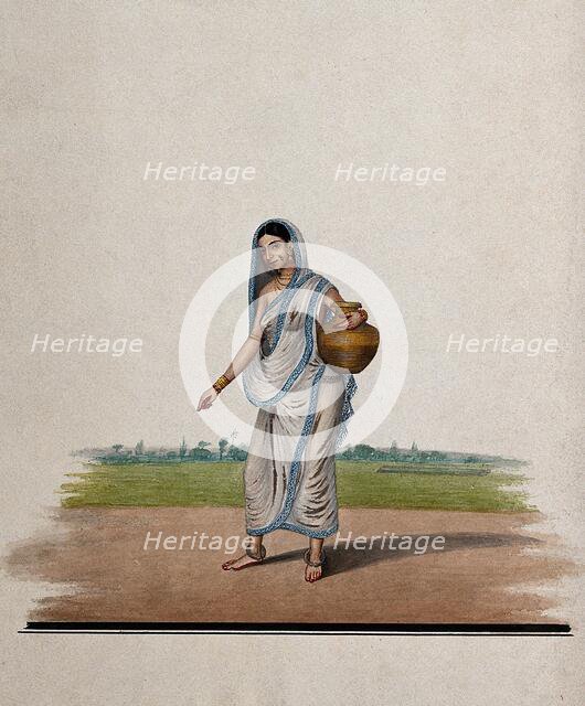 A woman carrying a brass utensil, (between 1800 and 1899?). Creator: Unknown.