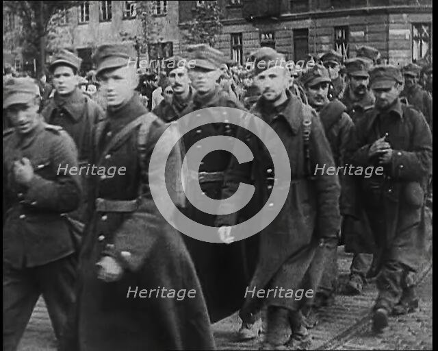 Male Polish Soldiers Walking Along a Warsaw Street, 1939. Creator: British Pathe Ltd.