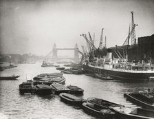View of the busy Thames looking towards Tower Bridge, London, c1920. Artist: Unknown