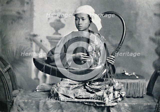 Burmese harp player, 1902. Artist: Unknown.