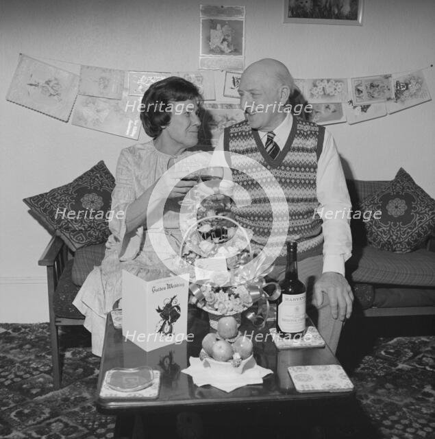 Mr and Mrs Birtmead toasting to their golden wedding anniversary, 26/04/1984. Creator: John Laing plc.
