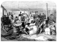 The Cotton Famine: making up parcels of clothing at the industrial institution, Manchester, 1862. Creator: Unknown.