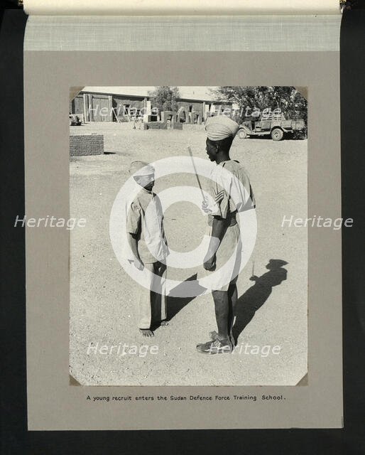 A young recruit enters the Sudan Defence Force Training School, 1964. Creators: Colonial Office, Unknown.
