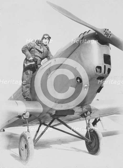 Aerial photographer getting into an aeroplane, c1930s. Creator: Aerofilms.