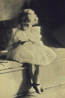 Seated girl reading a book, c1900. Creator: Eva Watson-Schutze.