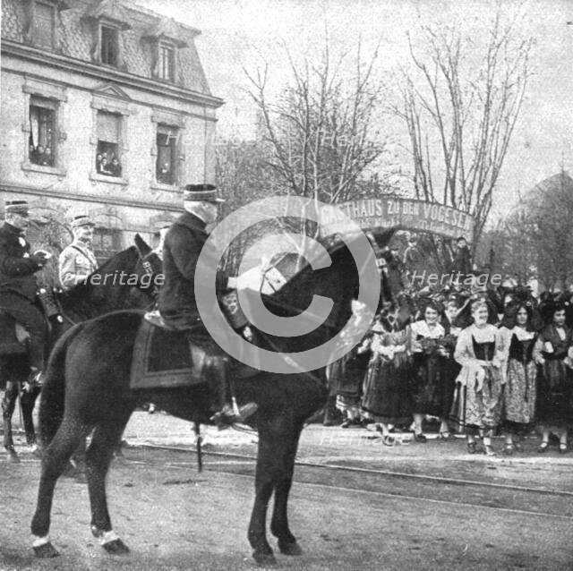 'Notre entrée a Colmar; Le general de Castelnau devant les drapeaux de la 169e division..., 1918. Creator: Unknown.