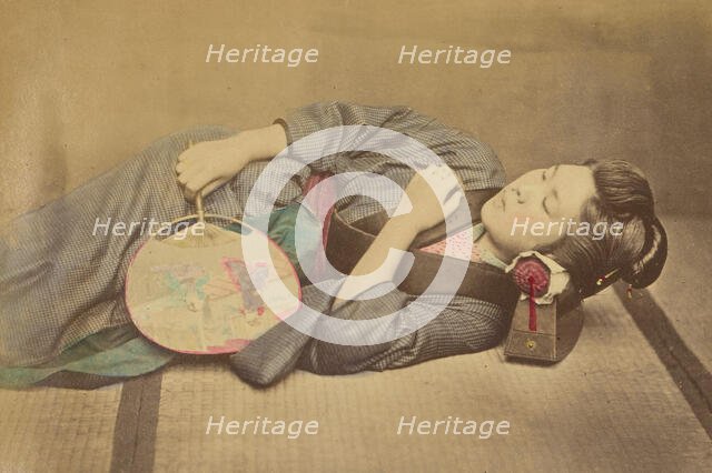 Sleeping Japanese woman holding a fan, 1868-1880. Creator: Felice Beato.