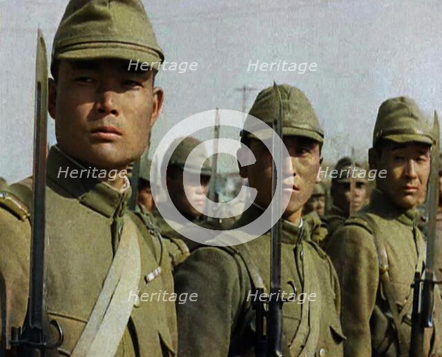 Close up of Male Japanese Soldiers Standing to Attention and Holding Their Bayonets Looking..., 1938 Creator: British Pathe Ltd.