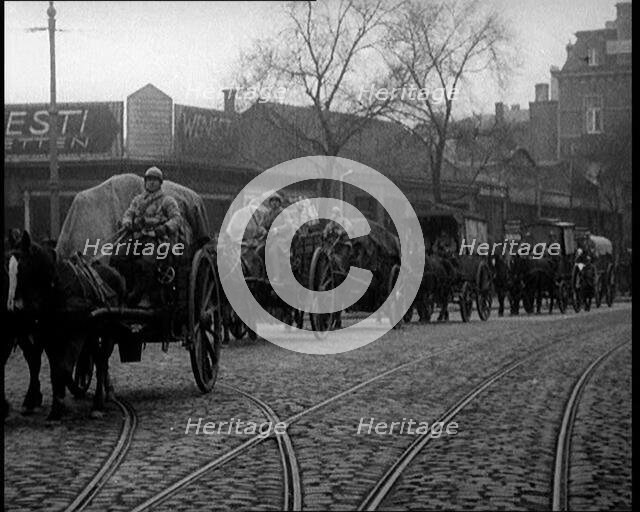 French Soldiers Escort Wagons Down a Cobbled Street, 1924. Creator: British Pathe Ltd.