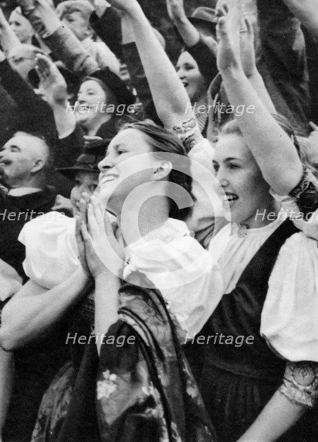 Admiring crowd saluting German Nazi leader Adolf Hitler, 1938. Artist: Unknown
