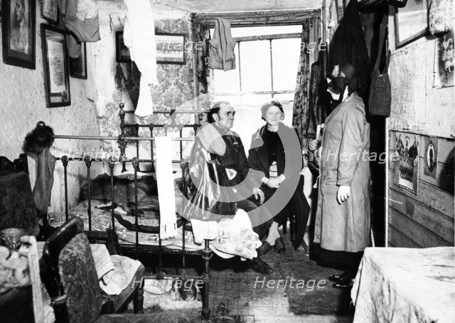 Salvation Army visiting a resident in Notting Hill, London, c1900. Artist: Unknown.