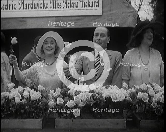 The Actors Helena Pickard and Cedric Hardwicke Holding Roses, 1920s. Creator: British Pathe Ltd.