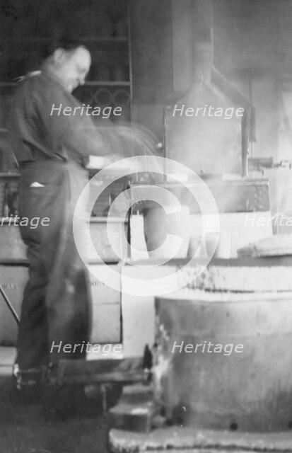 Mr. Kah smelting gold at the Assay Office, between c1900 and 1916. Creator: Unknown.