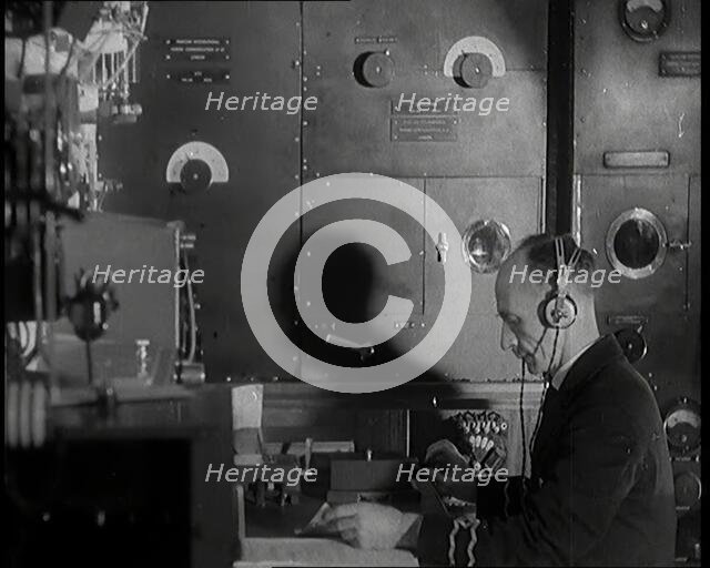 Interior of a Ship at Sea With Man at Work Operating a Communication System, 1920s. Creator: British Pathe Ltd.