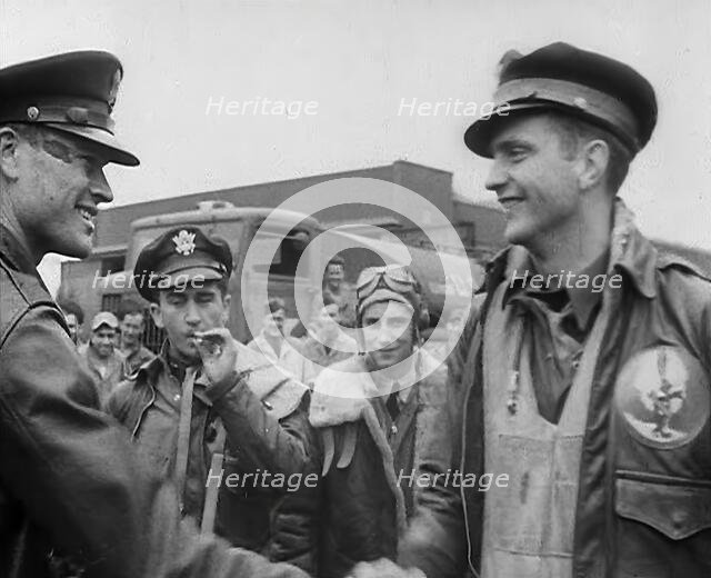 A Male Pilot Shaking Hands with an Officer, whilst other Pilots are Looking On, 1943-1944. Creator: British Pathe Ltd.