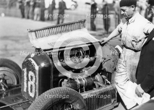 Attilio Marinoni, chief mechanic of Scuderia Ferrari, with an Alfa Romeo, 1934. Artist: Unknown