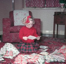 Girl opening her Christmas cards and presents, c1955.  Creator: Arthur Charles Kirby Ware.