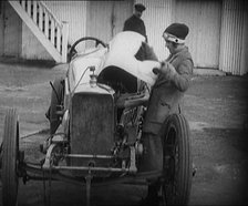 Racing Driver Ivy Cummins Wearing a Racing Outfit Opening a Bonnet of Her Car, 1920. Creator: British Pathe Ltd.