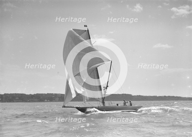 The 8 Metre sailing yacht 'Endrick' sailing downwind under spinnaker, 1911. Creator: Kirk & Sons of Cowes.