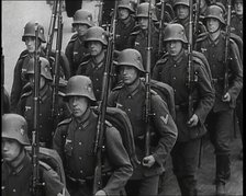 A Regiment of Male German Soldiers Marching Along a German Street, 1939. Creator: British Pathe Ltd.