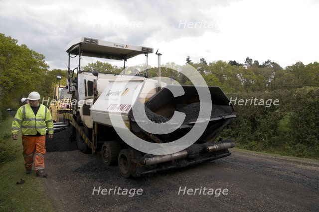 Road resurfacing work repairing potholes Artist: Unknown.