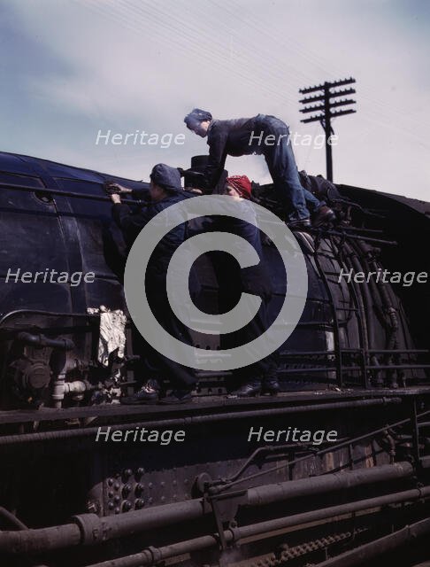 C. & N.W. R.R., women wipers at the roundhouse cleaning one of the giant..., Clinton, Iowa, 1943. Creator: Jack Delano.