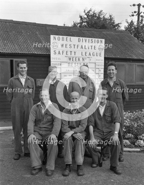 ICI powder works team in front of the Safety League board, Denaby Main, South Yorkshire, 1962. Artist: Michael Walters