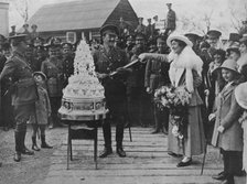'A khaki wedding: Cutting the wedding cake with the bridegroom's sword', 1915. Artist: Unknown.