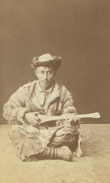 Kazakh man, a musician with a dombra, seated, between 1870 and 1886. Creator: Unknown.